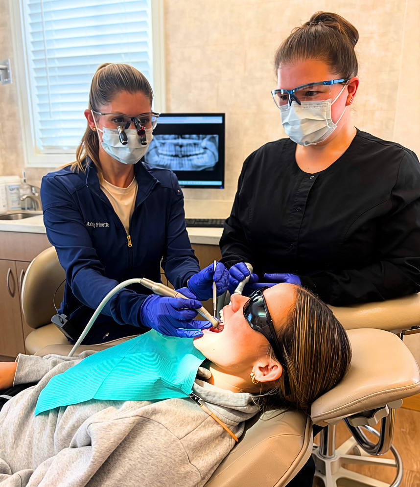 Dental assistant working with a patient